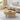 Wooden coffee table with a laptop, cup, and snacks in a living room setting.