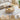 Round wooden coffee table with lift-top feature in a living room setting