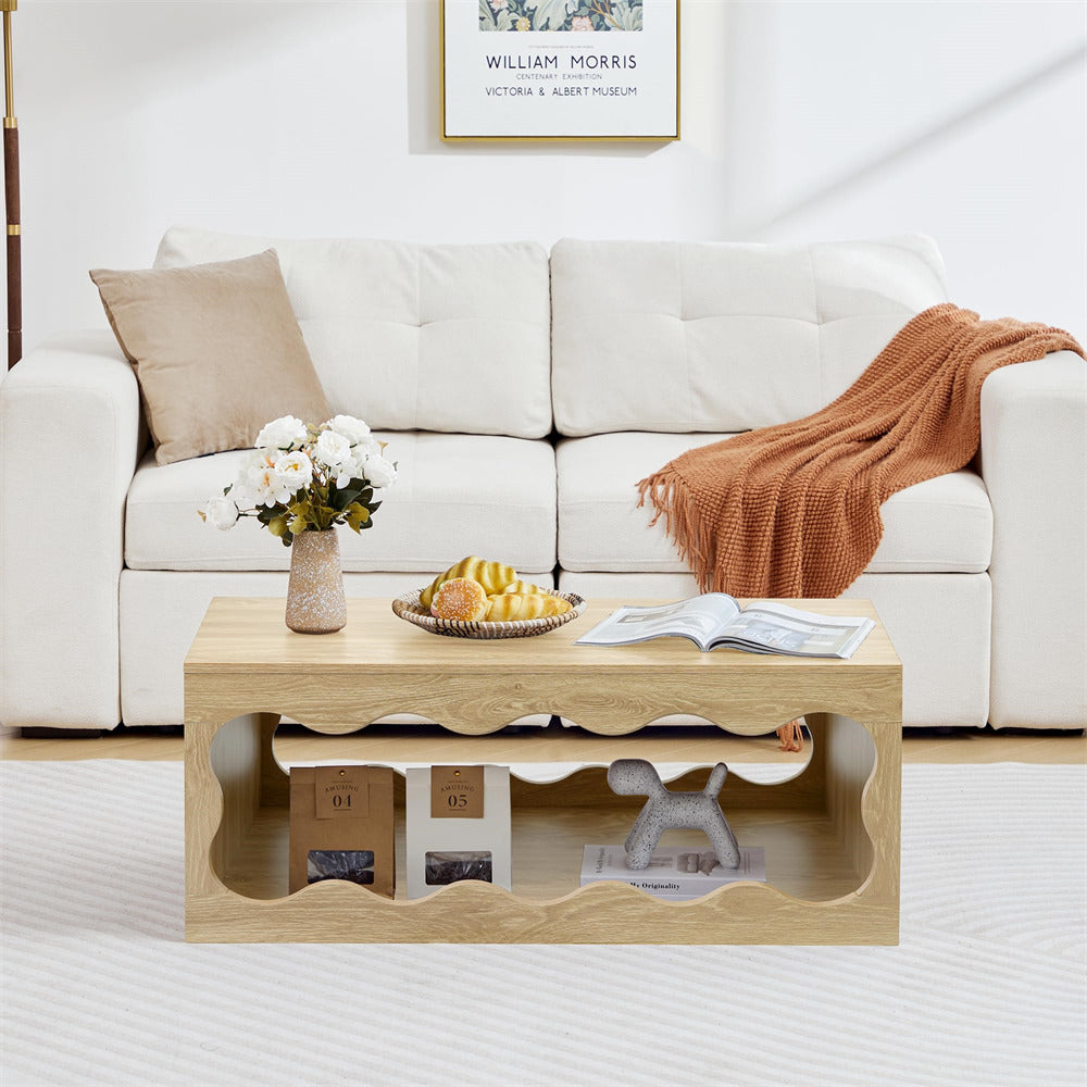 Light wood coffee table with decorative items in a living room setting.