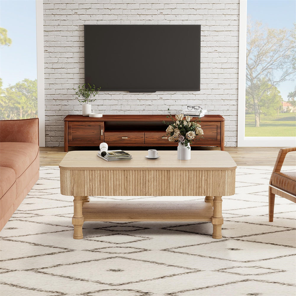 Living room with wooden coffee table, sofa, and TV against a brick wall.