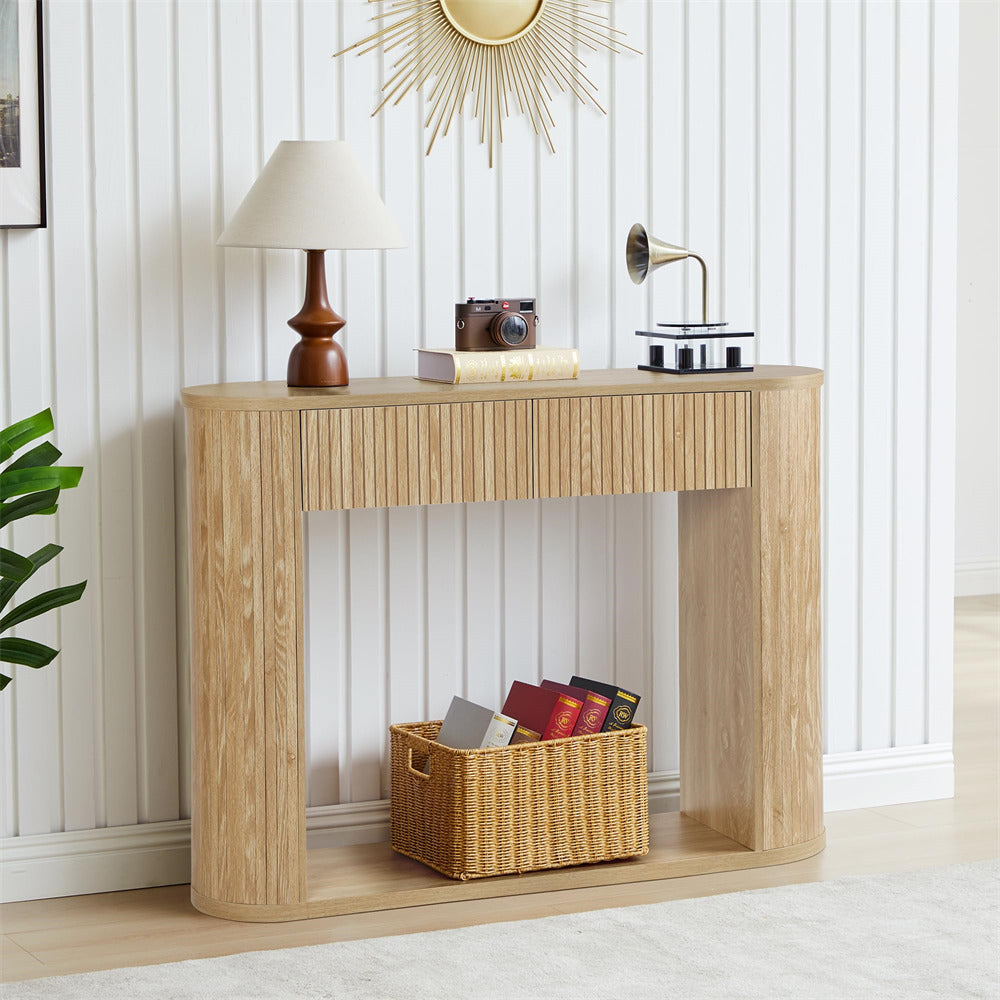 Wooden console table with decorative items in a room with white walls and a plant.