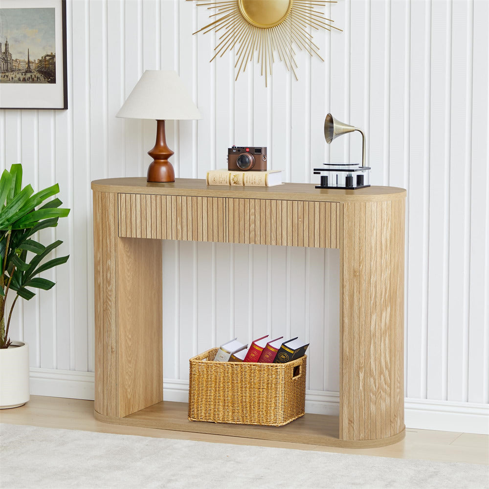 Wooden console table with decorative items against a white wall.