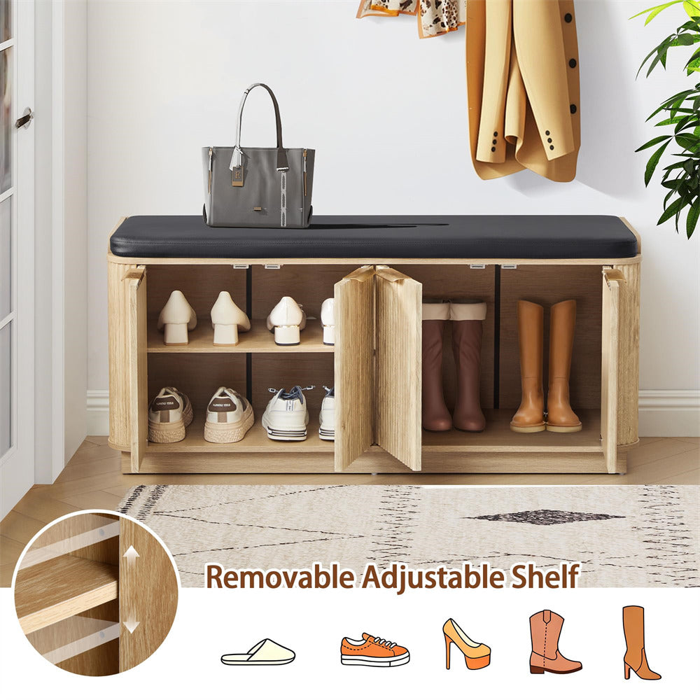 Wooden shoe bench with storage compartments, shoes, and a handbag on a light wooden floor.