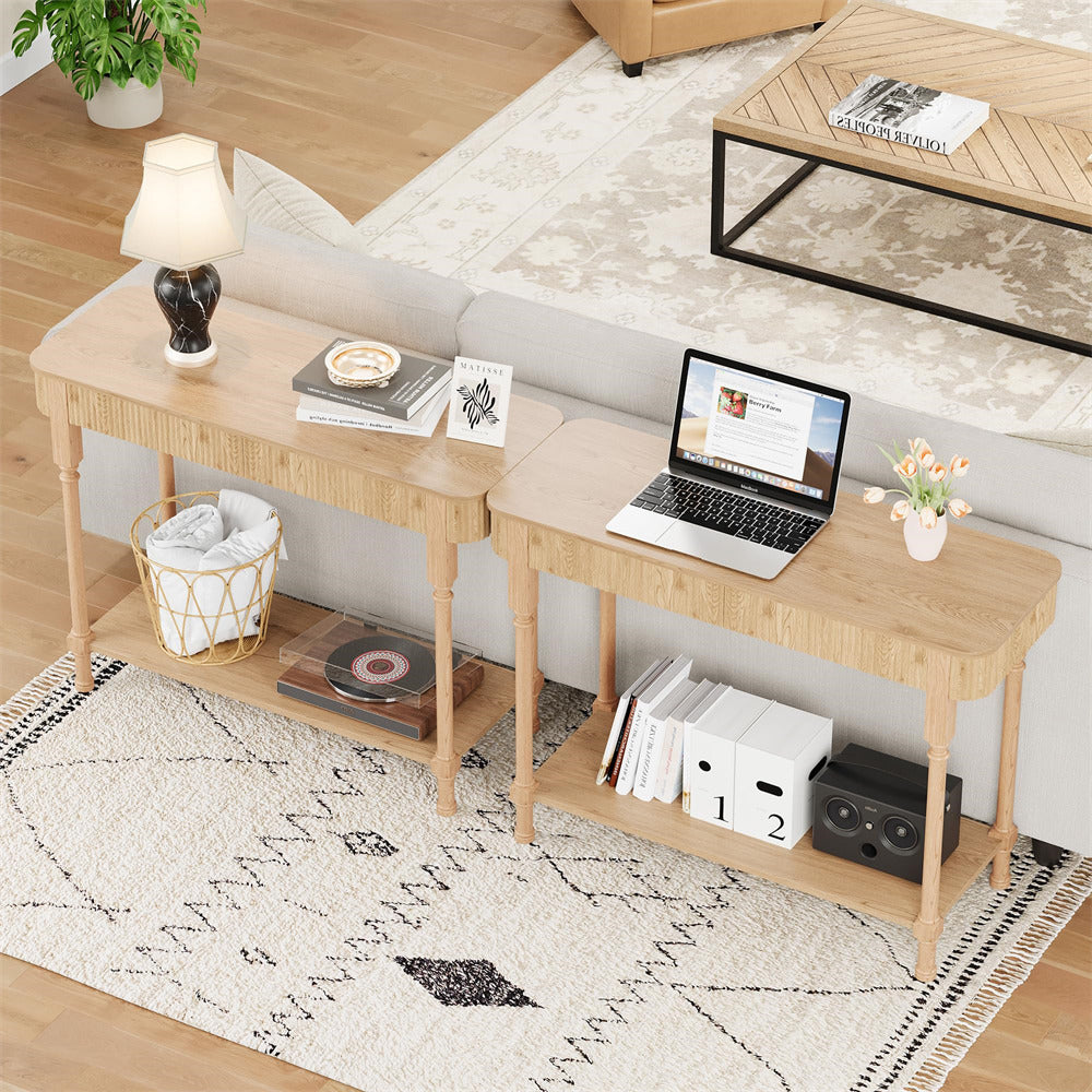 Wooden desk with laptop, books, and decor in a living room setting