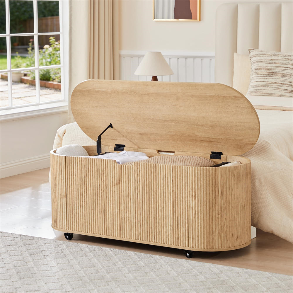 Wooden storage ottoman with open lid in a bedroom setting