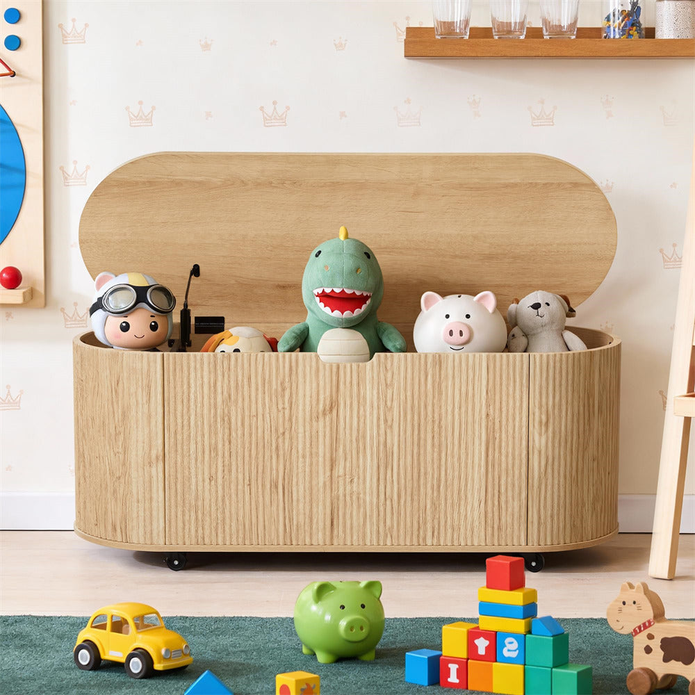 Wooden toy storage box with stuffed animals and toys on a wooden floor.