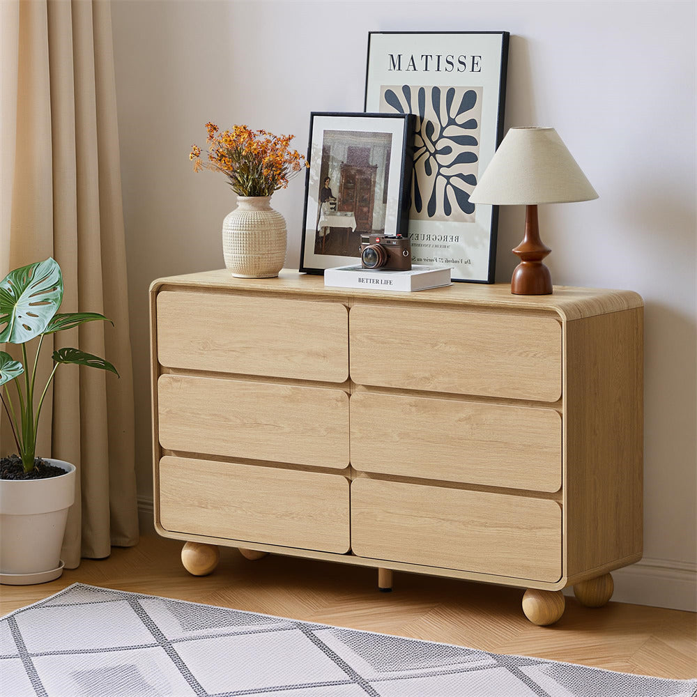 Wooden dresser with decorative items in a room setting