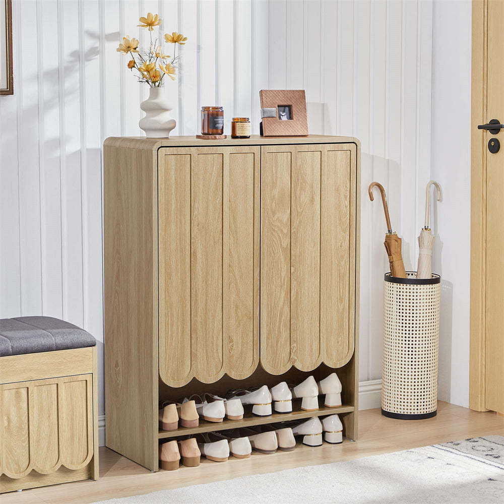 Wooden shoe cabinet with shoes inside, next to a bench and umbrella stand in a room.
