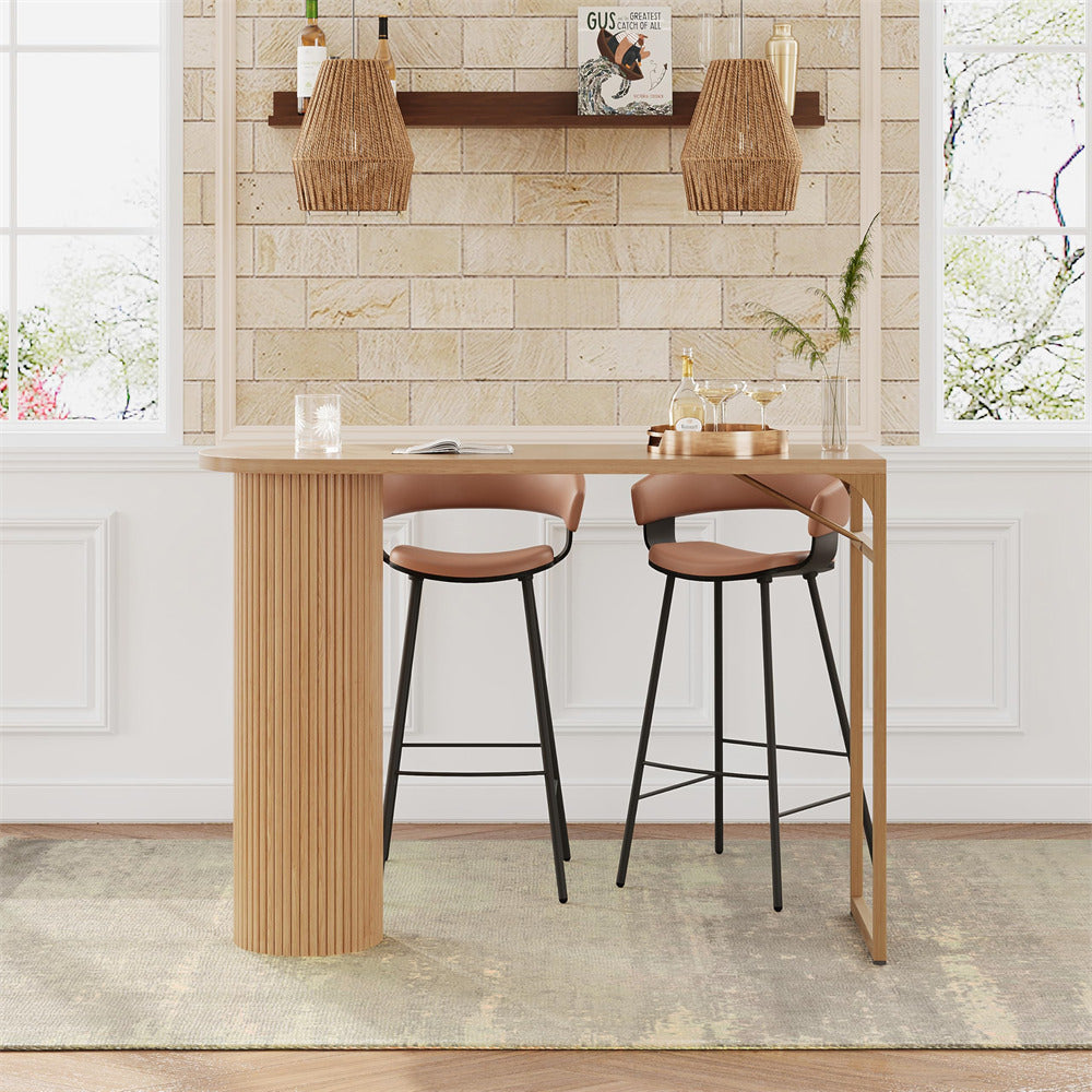 Wooden bar table with two stools against a tiled wall.