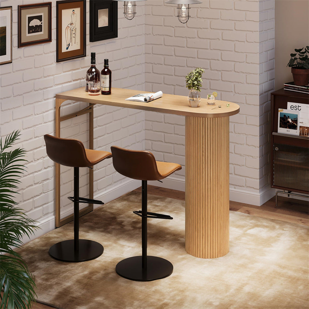 Wooden bar table with two stools against a white brick wall.