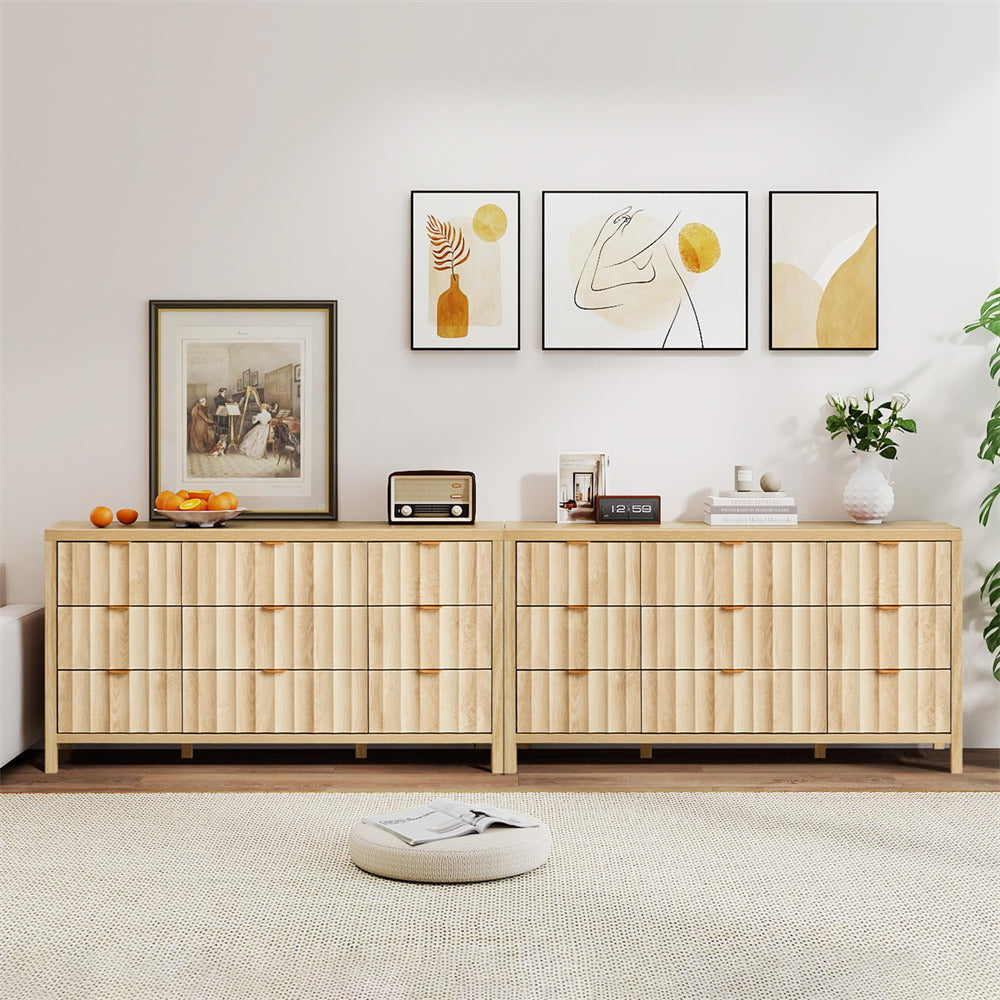 Wooden dresser with decorative items in a room with framed art on the wall.