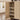 Wooden 5 Tier cabinet with adjustable shelves in a room with a window and shoes on the floor.