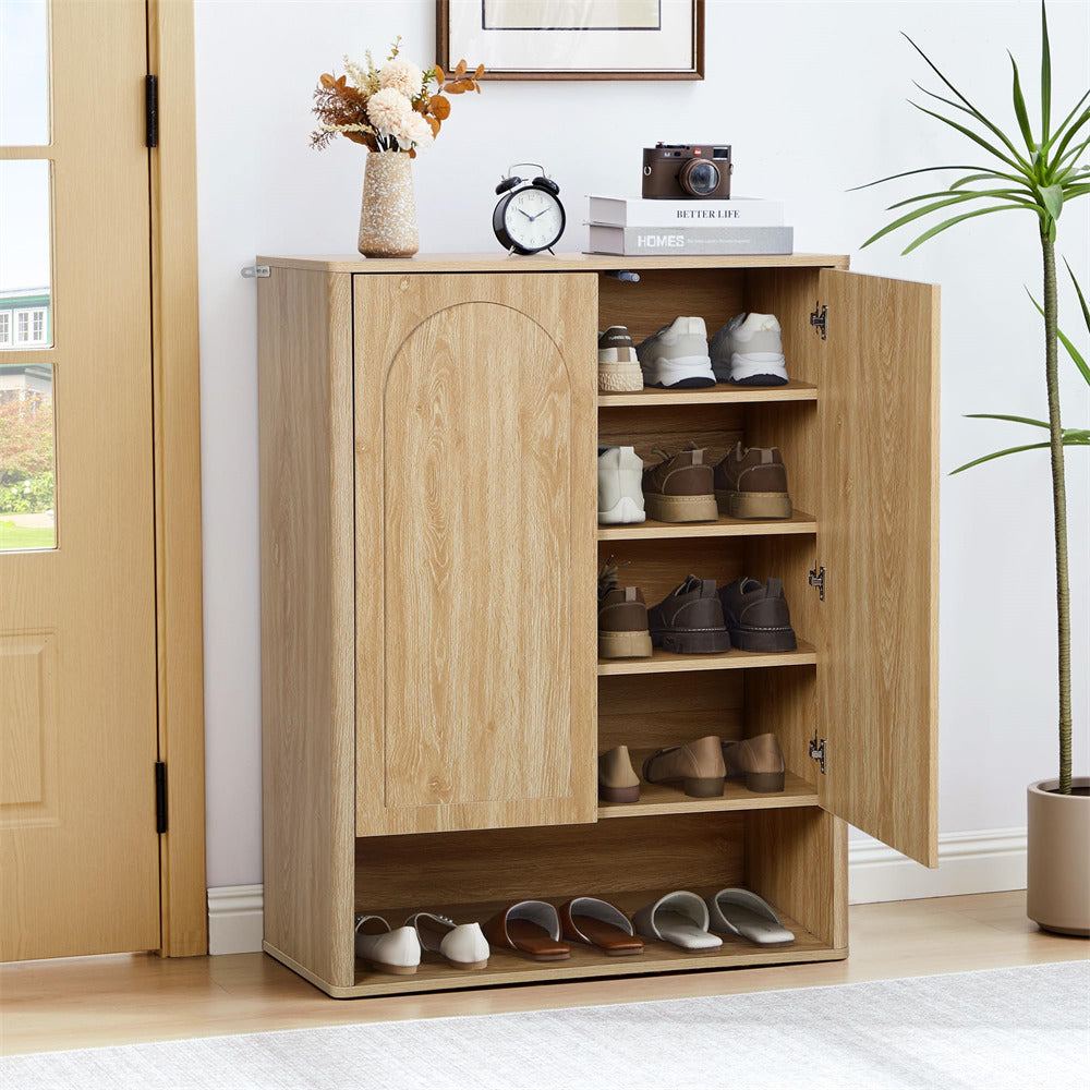 Wooden shoe cabinet with open doors displaying shoes, placed in a room with a plant and clock.