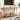 Wooden 63" console table in a living room with books, a basket labeled 'TOYS', and decorative items.