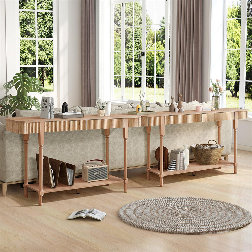Long wooden console table in a room with large windows and a rug on the floor.