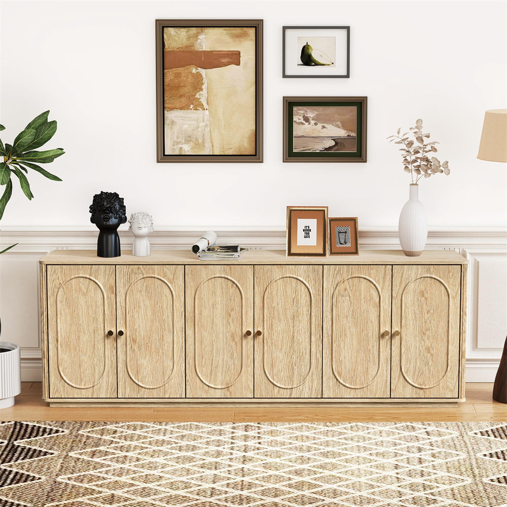 Wooden sideboard in a living room with decorative items and wall art.