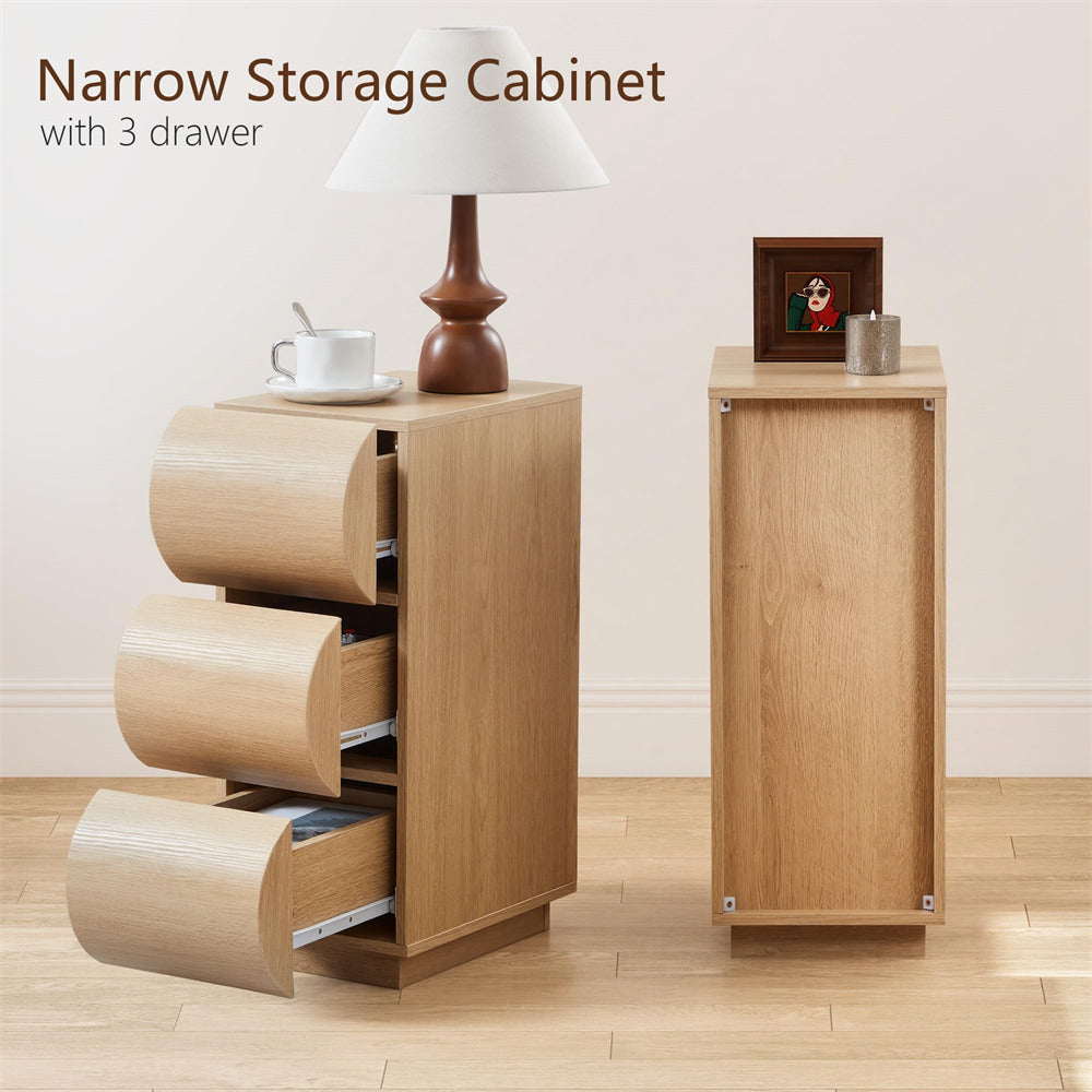 Narrow storage cabinet with three drawers on a wooden floor.