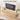 A floating light wood TV stand with a ribbed front and curved bottom edge, shown mounted against a white wall in a styled living room. A black TV, books, a small vase with greenery, and text reading 'Hidden Flip-Down Storage Keeps Your Living Room Clean & Organized' are visible.