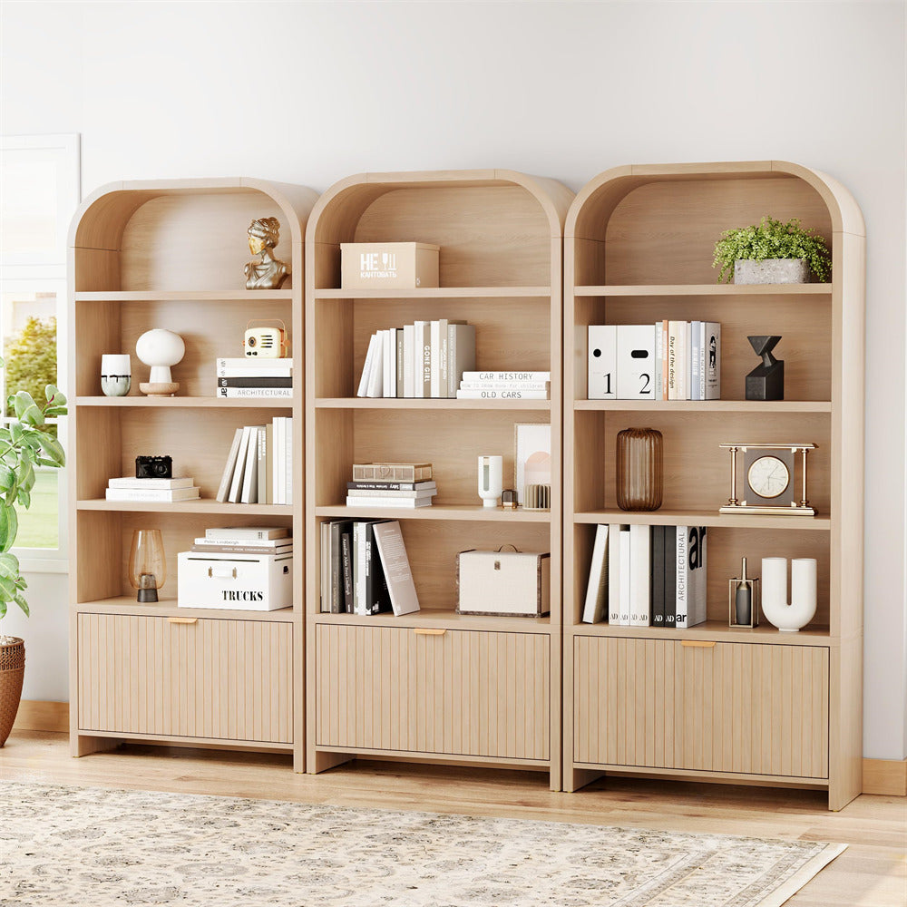 Wooden bookshelves with decorative items in a room with a light-colored floor and wall.
