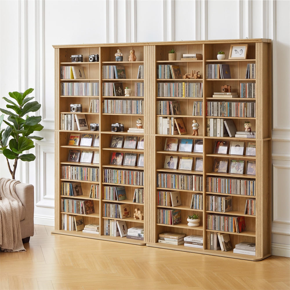 Large wooden bookshelf filled with books and decorative items in a room with a plant and sofa.