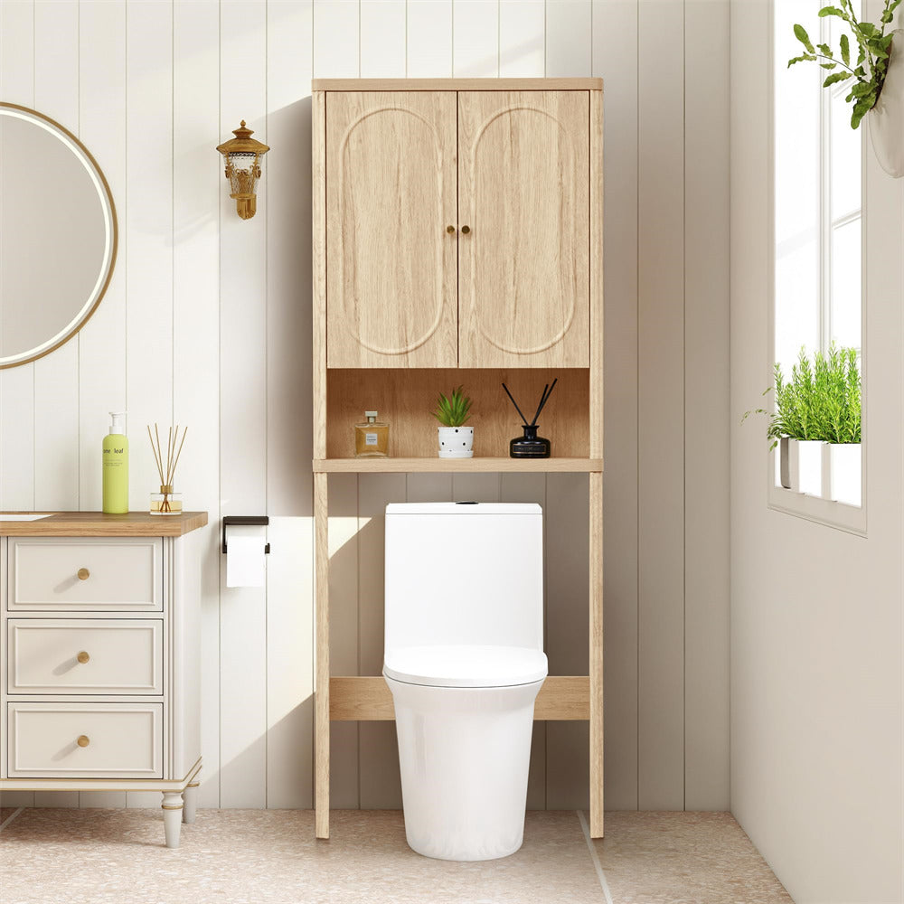 Bathroom with wooden cabinet over a toilet, white walls, and decorative elements.