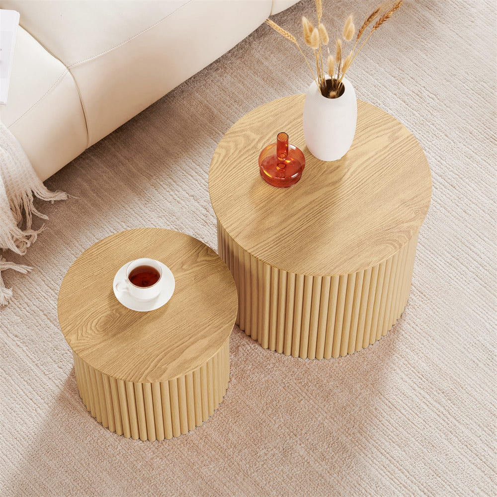 Two wooden side tables with decorative items on a beige carpeted floor.