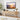Wooden TV stand with decorative items against a wall-mounted TV displaying a mountain scene.