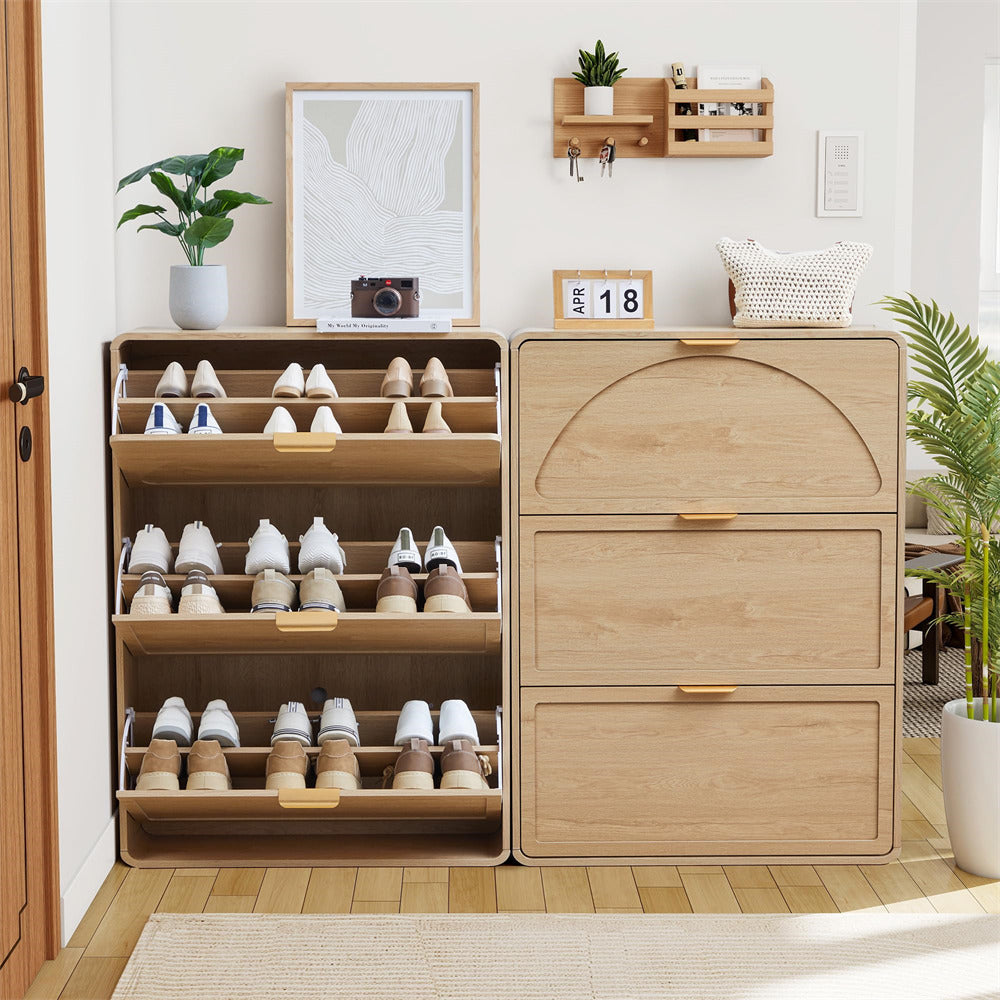 Wooden shoe cabinet with open door displaying shoes, against a white wall with decor elements.