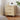 Wooden nightstand with decorative items against a neutral wall