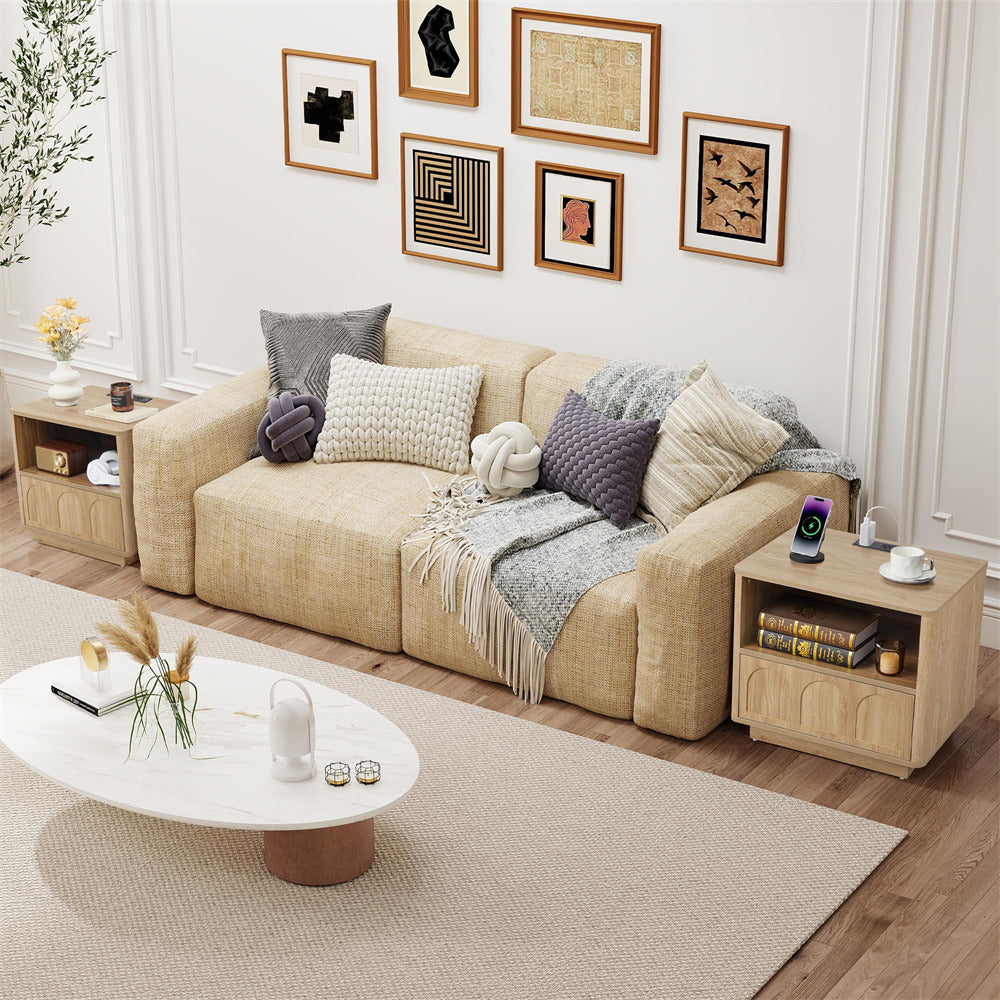 Modern living room with beige sofa, coffee table, and decorative items.