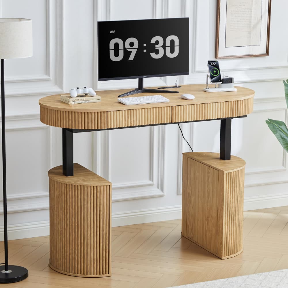 A modern curved wooden desk with black metal legs, styled in a bright home office setting with a computer monitor, keyboard, and other desk accessories.