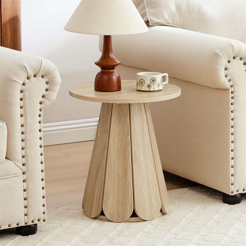 Small wooden side table with a lamp and mug in a living room setting.
