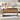Wooden coffee table with storage compartments in a living room setting.
