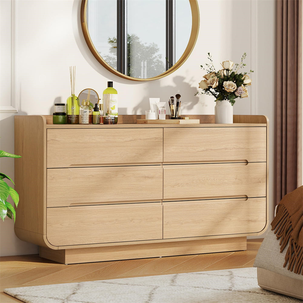 Wooden 6-drawer dresser with decorative items in a room setting