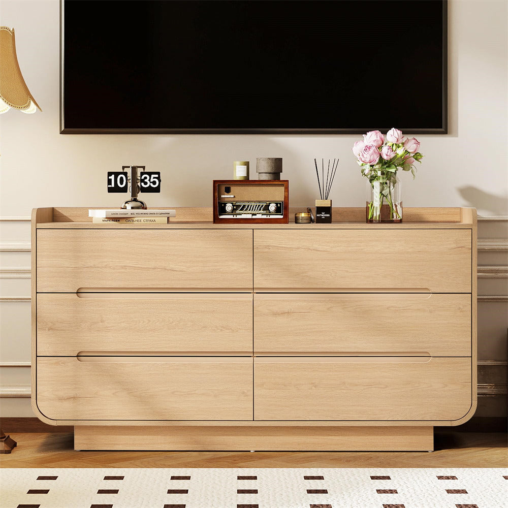 Wooden 6-drawer dresser with decorative items in a living room setting