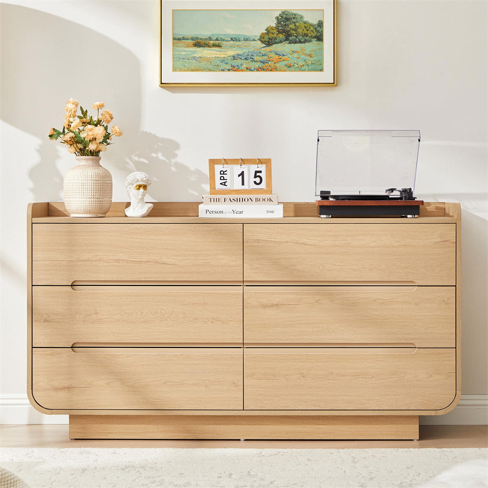 Wooden 6-drawer dresser with decorative items in a room setting
