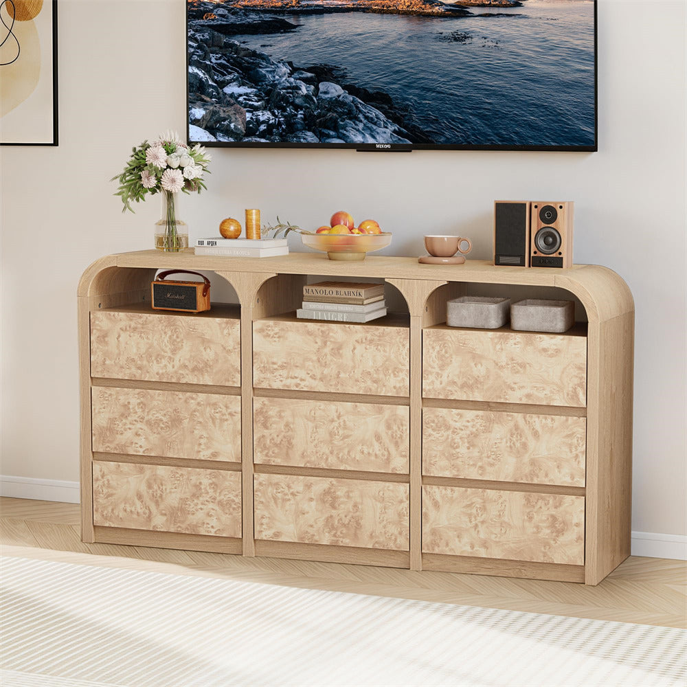 Light wood entertainment console with decorative items in a living room setting.