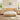 A light natural wood bed frame with a scalloped headboard, styled in a bright bedroom with matching nightstands, bedside lamps, and white bedding.