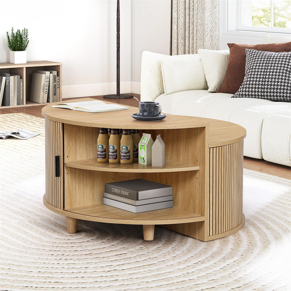 Wooden coffee table in a living room with books, bottles, and a cup.