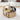Round wooden side table with storage compartment in a living room setting.