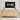 Wooden sideboard with decorative items and a digital clock on a wall.