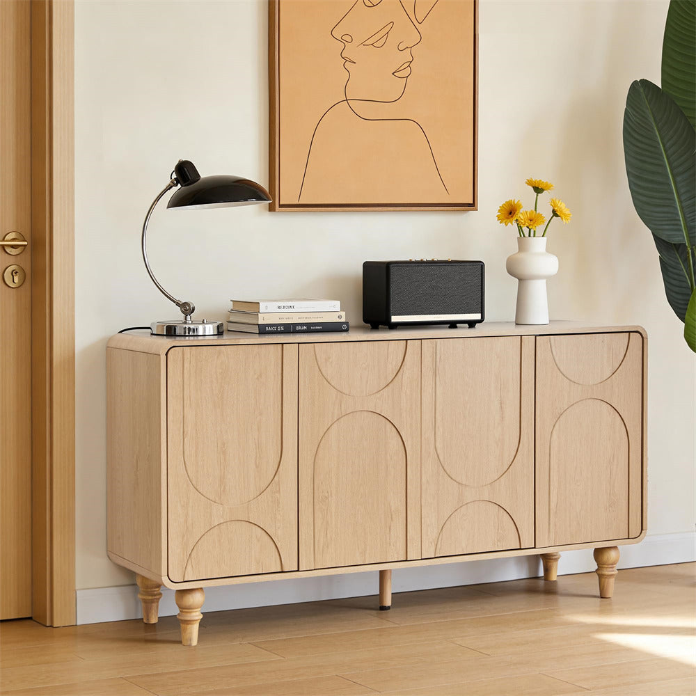 Wooden sideboard with decorative items in a room with a painting and plant.