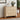 Wooden dresser with three drawers in a room with a plant and framed picture on the wall.