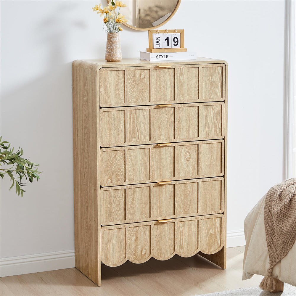 Wooden 5 drawer dresser with scalloped edges in a room setting