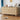 Wooden sideboard in a living room setting with decor items on top