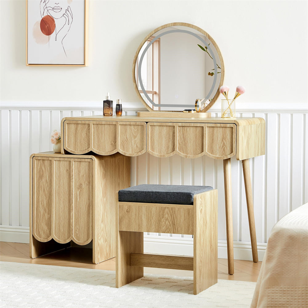 Wooden vanity table with round mirror and stool in a room setting.