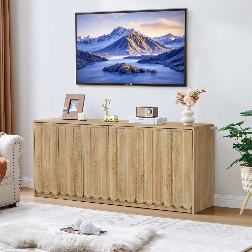 Wooden sideboard in a living room with decorative items and a TV displaying a mountain scene.