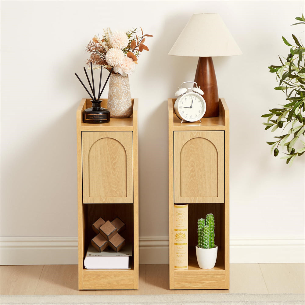Two wooden side tables with decorative items against a white wall.