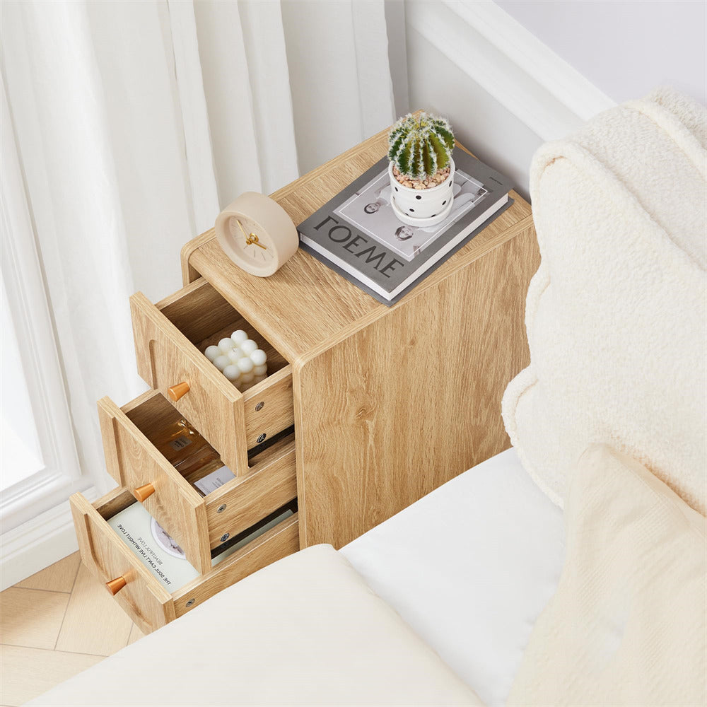 Wooden nightstand with open drawer next to a bed in a bedroom setting