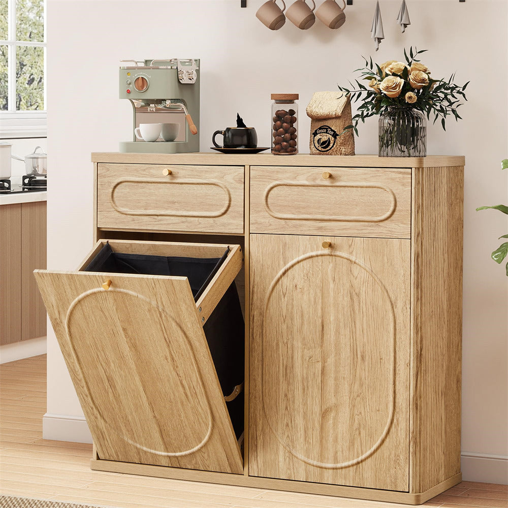Wooden kitchen cabinet with pull-out trash bin in a modern kitchen setting.